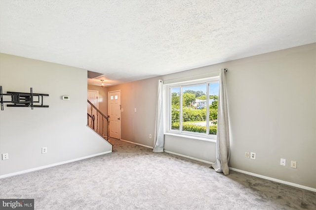 376 Jamie Ct, Glen Burnie, MD 21060 - unfurnished living room featuring carpet flooring, stairs, and a textured ceiling