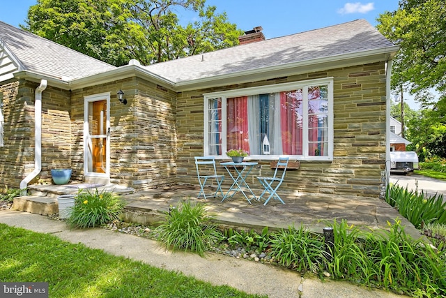 15 Overlook Ave, Lancaster, PA 17601 - view of front of house with stone siding, a chimney, and a shingled roof