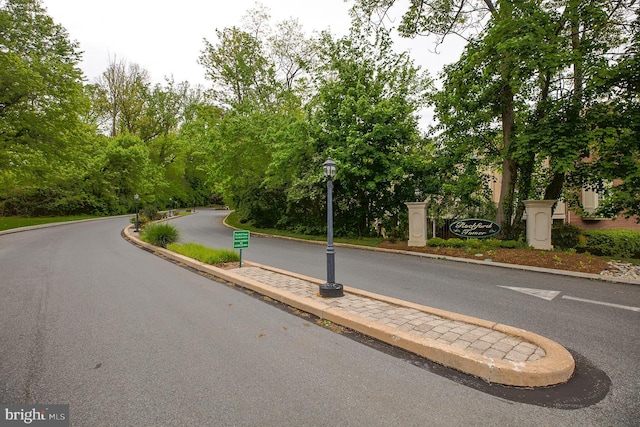 7 Rockford Rd Unit F1, Wilmington, DE 19806 - view of asphalt street featuring street lighting, curbs, and view of wooded area