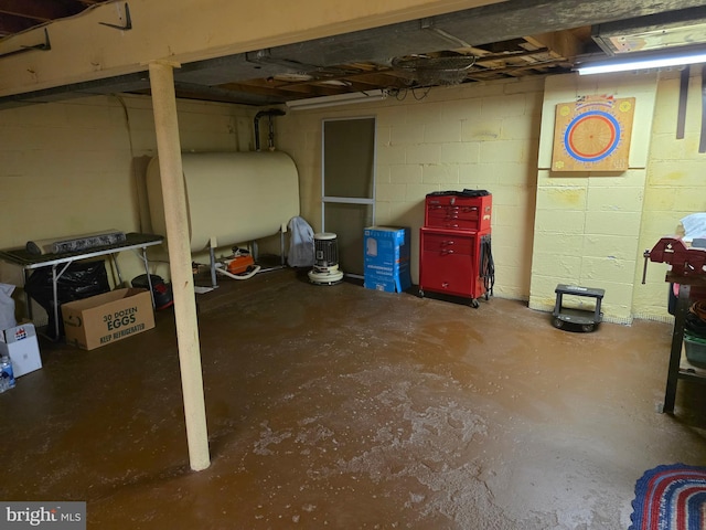 1220 Manatawny St, Pottstown, PA 19464 - unfinished below grade area featuring oil tank and concrete block wall