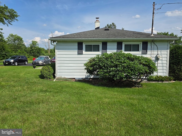 1220 Manatawny St, Pottstown, PA 19464 - view of home's exterior with a chimney and a yard