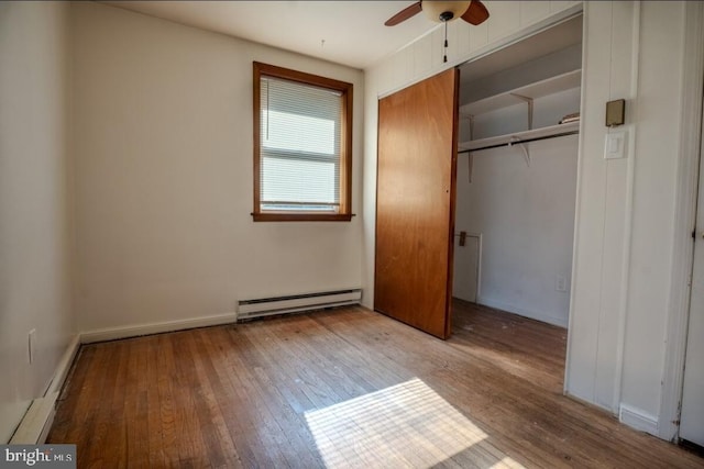 102 Spring St, Bridgeton, NJ 08302 - unfurnished bedroom featuring baseboard heating, hardwood / wood-style floors, and a closet