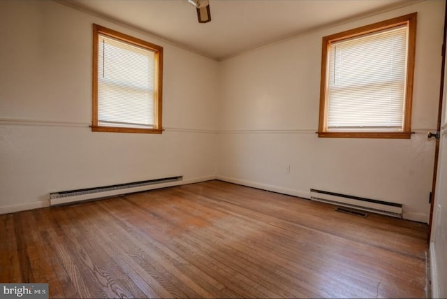 102 Spring St, Bridgeton, NJ 08302 - empty room featuring a baseboard heating unit, plenty of natural light, wood finished floors, ceiling fan, and ornamental molding