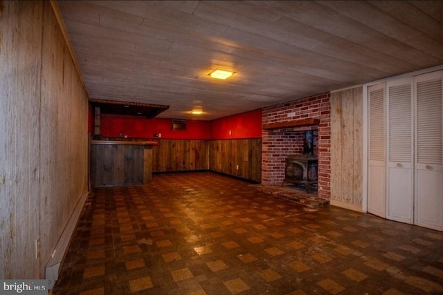 102 Spring St, Bridgeton, NJ 08302 - unfurnished living room with wooden walls, wood ceiling, bar area, and a wood stove
