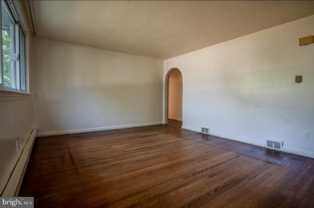 102 Spring St, Bridgeton, NJ 08302 - spare room featuring a baseboard radiator, arched walkways, and wood finished floors
