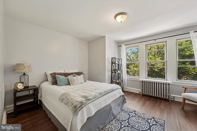 5788 Haddington St, Philadelphia, PA 19131 - bedroom featuring radiator heating unit, multiple windows, and wood finished floors