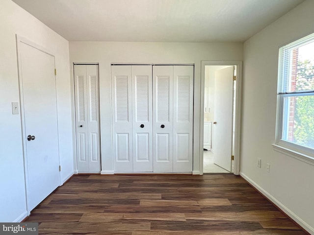 8305 Sunnyside Ct, Manassas Park, VA 20111 - unfurnished bedroom featuring multiple closets and dark wood-type flooring