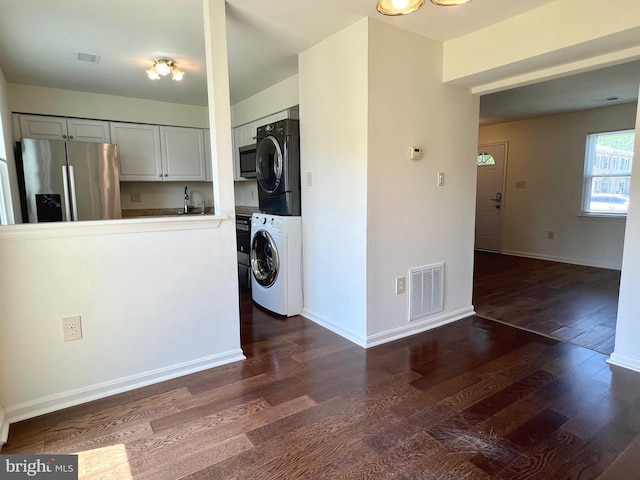 8305 Sunnyside Ct, Manassas Park, VA 20111 - laundry room featuring estacked washer and dryer and dark wood finished floors