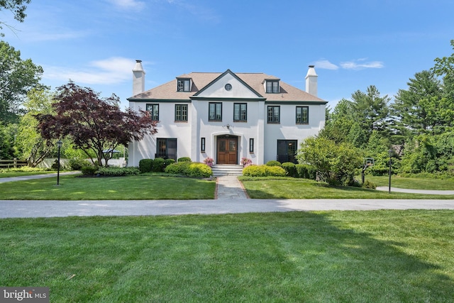 1263 Argyle Rd, Berwyn, PA 19312 - view of front facade with a chimney, stucco siding, a front yard, and french doors