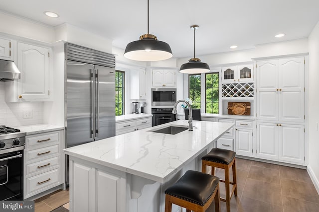 1263 Argyle Rd, Berwyn, PA 19312 - kitchen with built in appliances, healthy amount of natural light, tasteful backsplash, white cabinets, and recessed lighting
