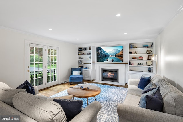 1263 Argyle Rd, Berwyn, PA 19312 - living area with ornamental molding, wood finished floors, a fireplace with flush hearth, and recessed lighting