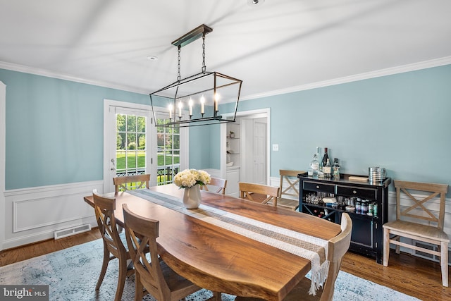 1263 Argyle Rd, Berwyn, PA 19312 - dining area with a chandelier, ornamental molding, wood finished floors, and wainscoting
