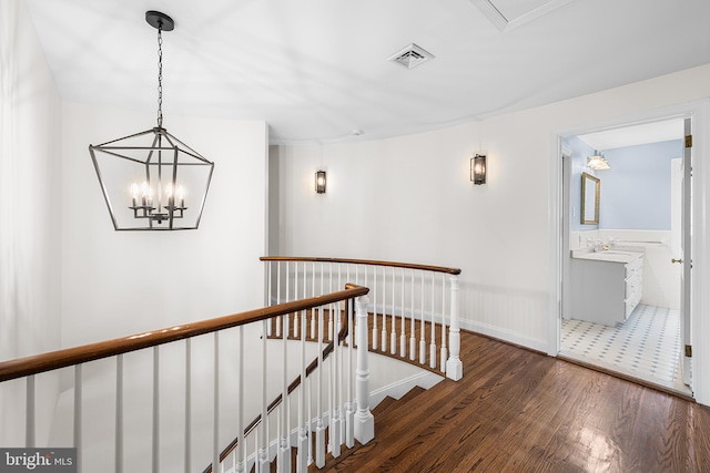 1263 Argyle Rd, Berwyn, PA 19312 - corridor with an upstairs landing, wood finished floors, and a chandelier