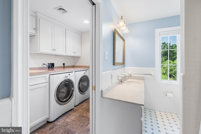 1263 Argyle Rd, Berwyn, PA 19312 - laundry area with washing machine and dryer, cabinet space, tile walls, and wainscoting