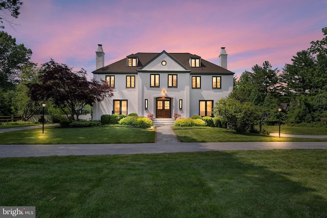 1263 Argyle Rd, Berwyn, PA 19312 - french country style house featuring a chimney, a front lawn, and stucco siding