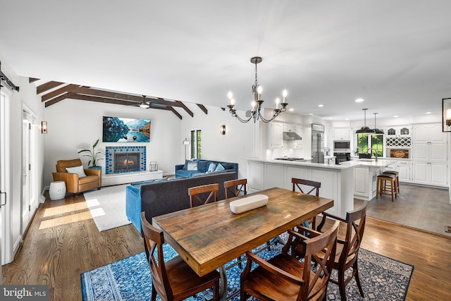 1263 Argyle Rd, Berwyn, PA 19312 - dining area featuring dark wood-style floors, a glass covered fireplace, ceiling fan, recessed lighting, and a chandelier