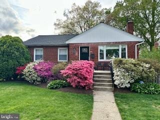 10002 Portland Pl, Silver Spring, MD 20901 - view of front of property featuring a chimney, a front yard, and brick siding
