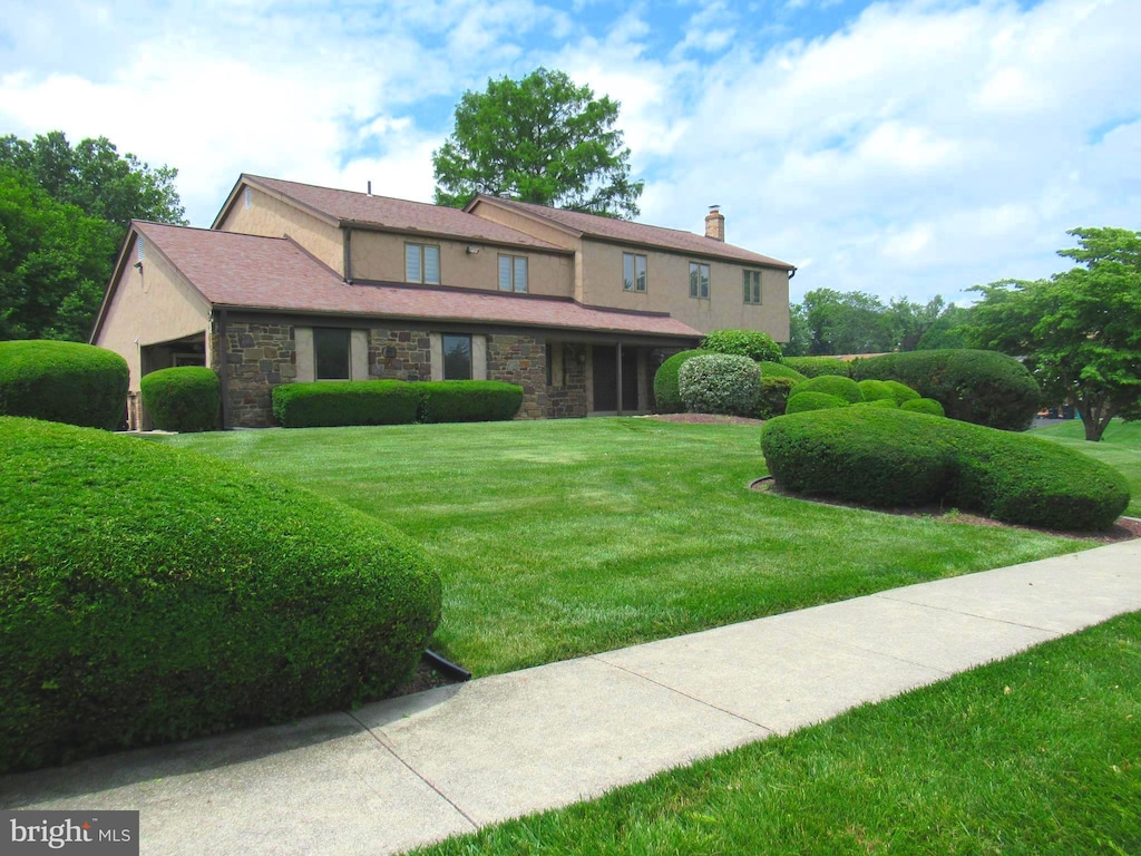 3632 Wheatsheaf Rd, Huntingdon Valley, PA 19006 - view of front facade featuring stone siding, a front lawn, a chimney, and stucco siding