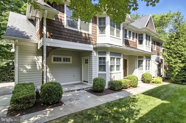6838 Saint Albans Rd, Mclean, VA 22101 - view of front facade featuring a standing seam roof, a shingled roof, a metal roof, and a front lawn