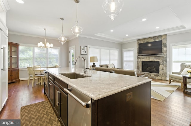 6838 Saint Albans Rd, Mclean, VA 22101 - kitchen featuring stainless steel dishwasher, a stone fireplace, a chandelier, dark wood-style floors, and dark brown cabinetry