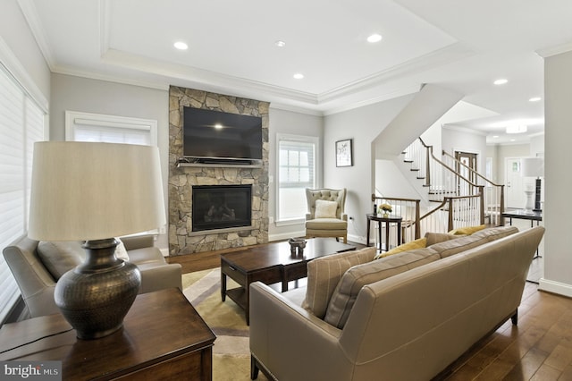 6838 Saint Albans Rd, Mclean, VA 22101 - living room with wood finished floors, stairs, a fireplace, a tray ceiling, and ornamental molding