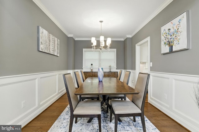 6838 Saint Albans Rd, Mclean, VA 22101 - dining room featuring a chandelier, ornamental molding, dark wood-style flooring, a wainscoted wall, and a decorative wall