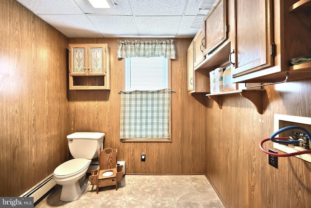 545 W King St, Littlestown, PA 17340 - bathroom with baseboard heating, wooden walls, and a paneled ceiling