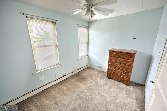 545 W King St, Littlestown, PA 17340 - unfurnished bedroom featuring a baseboard heating unit, multiple windows, carpet flooring, and a ceiling fan