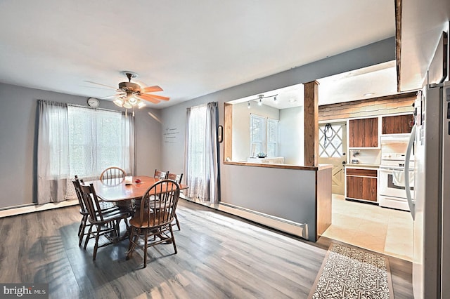 545 W King St, Littlestown, PA 17340 - dining room with light wood-type flooring, ceiling fan, a baseboard heating unit, and rail lighting