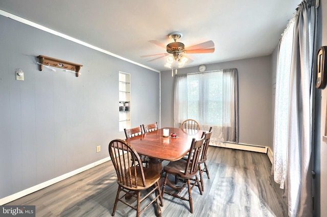 545 W King St, Littlestown, PA 17340 - dining room with wood finished floors, a baseboard heating unit, and a ceiling fan