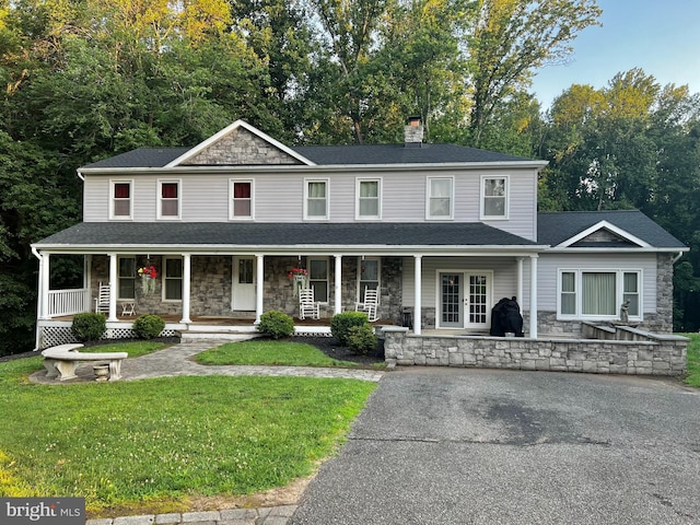 39360 Thomas Dr, Mechanicsville, MD 20659 - view of front of property with stone siding, a porch, a front lawn, and a chimney