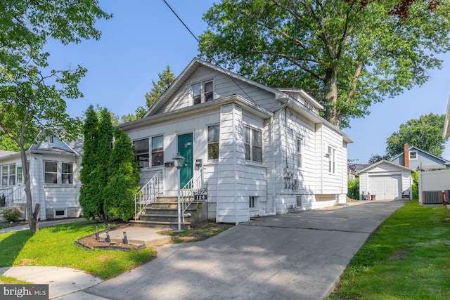 124 E Ormond Ave, Haddon Township, NJ 08107 - view of front of house featuring asphalt driveway, an outbuilding, entry steps, a garage, and a front lawn