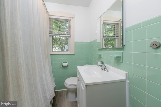 124 E Ormond Ave, Haddon Township, NJ 08107 - full bathroom with vanity, tile walls, wood finished floors, a wainscoted wall, and a shower with curtain