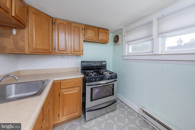 124 E Ormond Ave, Haddon Township, NJ 08107 - kitchen featuring stainless steel gas stove, light floors, light countertops, a baseboard heating unit, and brown cabinets
