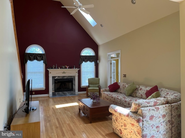 7 Camas Ct, Plainsboro, NJ 08536 - living area featuring high vaulted ceiling, hardwood / wood-style floors, a premium fireplace, ceiling fan, and healthy amount of natural light