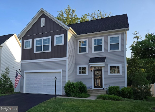 12141 Aster Rd, Bristow, VA 20136 - traditional-style home featuring a garage, asphalt driveway, a shingled roof, and board and batten siding