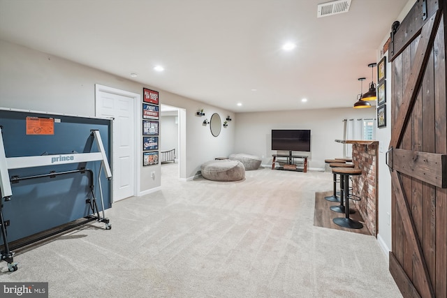 12141 Aster Rd, Bristow, VA 20136 - living area with a barn door, carpet flooring, and recessed lighting