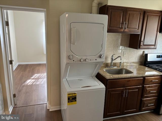 5755 E Capitol St SE, Washington, DC 20019 - washroom with stacked washer / drying machine and dark wood-style floors