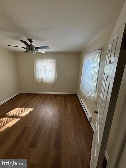 5755 E Capitol St SE, Washington, DC 20019 - unfurnished room featuring a baseboard radiator, healthy amount of natural light, and dark wood-type flooring