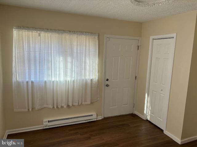 5755 E Capitol St SE, Washington, DC 20019 - entrance foyer with a baseboard radiator, dark wood-type flooring, and healthy amount of natural light