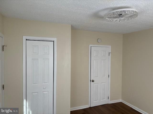 5755 E Capitol St SE, Washington, DC 20019 - unfurnished bedroom featuring dark wood-style flooring and a textured ceiling