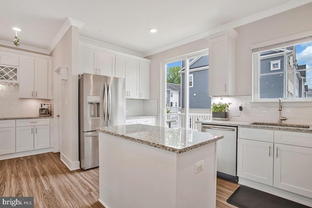 113 Treblis Way, Annapolis, MD 21403 - kitchen featuring appliances with stainless steel finishes, crown molding, decorative backsplash, white cabinetry, and light wood-type flooring