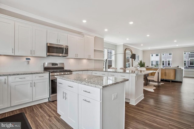 113 Treblis Way, Annapolis, MD 21403 - kitchen featuring appliances with stainless steel finishes, a peninsula, dark wood-style floors, a center island, and white cabinetry