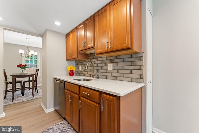 8573 Chester Grove Ct, Springfield, VA 22153 - kitchen featuring stainless steel dishwasher, brown cabinets, tasteful backsplash, light countertops, and recessed lighting