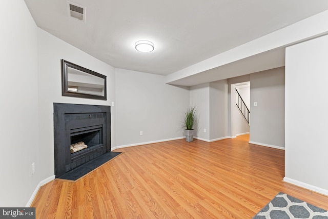 8573 Chester Grove Ct, Springfield, VA 22153 - unfurnished living room with light wood-style floors, stairway, and a fireplace