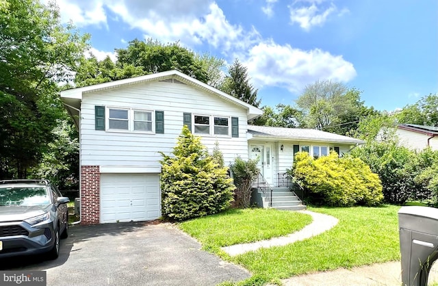 45 Browning Ave, Ewing, NJ 08638 - tri-level home with an attached garage, driveway, a front lawn, and brick siding