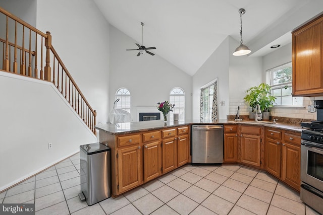 13297 Osage Dr, Woodbridge, VA 22193 - kitchen with appliances with stainless steel finishes, a peninsula, high vaulted ceiling, brown cabinets, and a ceiling fan