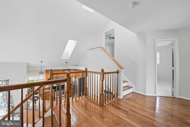13297 Osage Dr, Woodbridge, VA 22193 - hallway with a skylight, hardwood / wood-style floors, healthy amount of natural light, lofted ceiling, and an upstairs landing