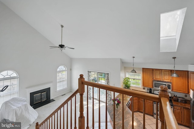 13297 Osage Dr, Woodbridge, VA 22193 - living room with high vaulted ceiling, a ceiling fan, a fireplace with flush hearth, and light tile patterned floors