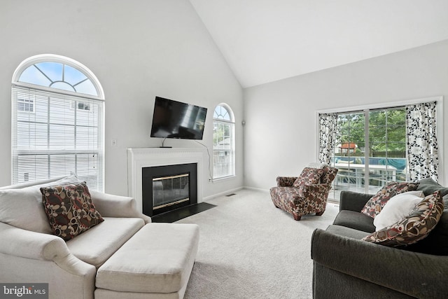 13297 Osage Dr, Woodbridge, VA 22193 - living room featuring carpet floors, high vaulted ceiling, and a fireplace with flush hearth